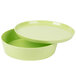 A lime green melamine round container with a lid.