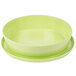 A lime green melamine bowl with a green lid and two plates on top.