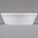 A white rectangular melamine bowl with a white border on a white surface.