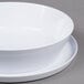 A white melamine bowl with a lid on top.