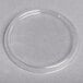 A clear plastic circle lid on a white surface.