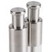 Two American Metalcraft stainless steel salt and pepper mills on a counter.