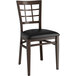 A Lancaster Table & Seating metal window back chair with a black cushion.
