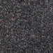 A close up of a gunmetal carpet with red and black fibers.