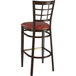 A Lancaster Table & Seating brown metal bar stool with a dark walnut wood grain finish and burgundy vinyl seat.