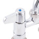 A close-up of an Equip by T&amp;S deck-mount faucet with blue handles.