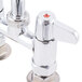 A chrome Equip by T&S deck-mount faucet with two handles and a swivel nozzle.