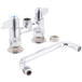 A chrome Equip by T&S deck-mount faucet with two handles and a swivel base.