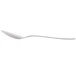 An Arcoroc stainless steel demitasse spoon with a curved edge and white handle.