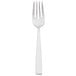 An Arcoroc stainless steel salad fork with a white handle.