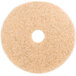 A circular 3M tan floor pad with a hole in the middle on a white background.