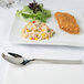 A plate of food with an Arcoroc stainless steel dinner spoon.