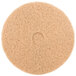 A 3M tan burnishing floor pad, a circular tan pad with a circle in the middle.
