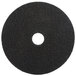A 3M black circular floor pad with a hole in the center.