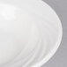 A CAC white porcelain monkey dish with a curved edge.