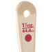 A beige polycarbonate measuring spoon with red numbers and text.