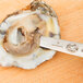 A Victorinox Boston style oyster knife with a red handle cutting open an oyster.