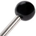 A black ball on a metal rod with a handle.