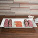An American Metalcraft Antique White Melamine platter with sliced meat and cheese on it.