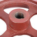 An Avantco red metal wheel with a hole in the center.
