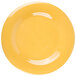 A close up of a yellow plate with a white wide rim.