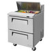A Turbo Air stainless steel refrigerated sandwich prep table with 2 drawers full of food.