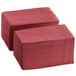 A stack of burgundy Choice 2-ply paper dinner napkins.