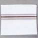 A white cloth napkin with brown stripes.