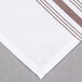 A white table with chocolate brown striped Snap Drape Softweave cloth napkins.