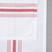 A white cloth napkin with red stripes.