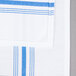 A blue and white striped Snap Drape Softweave cloth napkin.