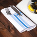 A plate of mussels and a fork on a blue and white striped Snap Drape Softweave napkin.