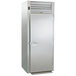 A stainless steel Traulsen roll-thru refrigerator with a door open.