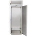 A silver Traulsen roll-thru refrigerator with a white door open.