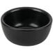 A black Hall China Jung bowl with a white background.