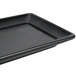 A black rectangular Hall China platter on a white counter.