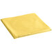 A folded mimosa yellow Creative Converting plastic table cover on a white background.