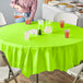 A table with a Fresh Lime Green OctyRound table cover and bowls of food.