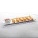 A Libbey ultra bright white rectangular porcelain tray with fried shrimp and dipping sauce.