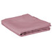 A folded pink square Intedge table cover on a white background.