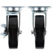 A pair of Vulcan and Wolf casters with black rubber wheels and a chrome plated rectangular plate.