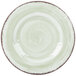 A close up of a Carlisle Jade melamine salad plate with a white swirly surface and green rim.