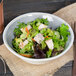 A Carlisle smoke melamine bowl filled with salad with chicken and vegetables.