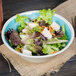 A Carlisle Aqua Melamine bowl filled with salad with chicken and carrots.