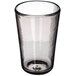 A Carlisle clear Tritan plastic beverage glass with a wavy texture and a small bottom.