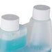 A white plastic container of Urnex Rinza Milk Frother Cleaner with blue liquid inside.