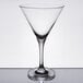 A close-up of a clear Stolzle martini glass with a short stem and a rim.