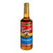 A Torani Cinnamon Flavoring Syrup 750 mL glass bottle with a red label.