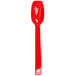 A red plastic spoon with a handle.