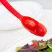 A red Cambro salad bar spoon with tomatoes on it.